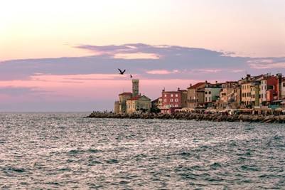 Piranski svetilnik light tower in the sunset on the coastline in Piran